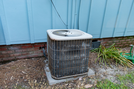 a rusty outdoor AC condenser unit
